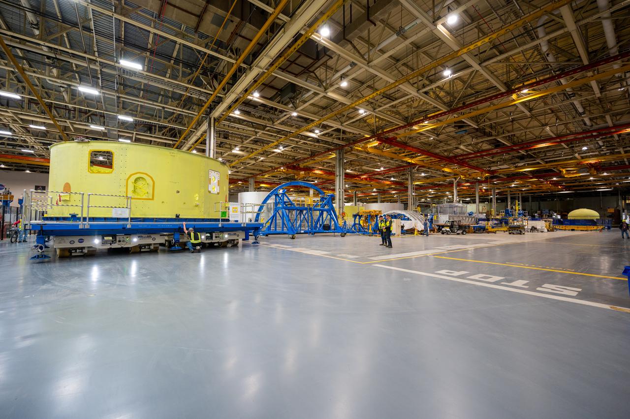 Crews at NASA’s Michoud Assembly Facility in New Orleans move the forward skirt of NASA’s Space Launch System (SLS) rocket to another part of the facility Dec. 15. Teams are preparing to apply the thermal protection system to the flight hardware, which will protect it from the extreme temperatures during launch and flight. The forward skirt is part of the core stage that will power the SLS rocket for the Artemis III mission. The forward skirt houses flight computers, cameras, and avionics.. The SLS core stage is made up of five unique elements: the forward skirt, liquid oxygen tank, intertank, liquid hydrogen tank, and the engine section. When fully stacked, the forward skirt is located at the top of the core stage and connects the stage to the upper part of the rocket. Together with its four RS-25 engines, the rocket’s massive 212-foot-tall core stage — the largest stage NASA has ever built — and its twin solid rocket boosters produce 8.8 million pounds of thrust to send NASA’s Orion spacecraft, astronauts and supplies beyond Earth’s orbit to the Moon and, ultimately, Mars. Offering more payload mass, volume capability and energy to speed missions through space, the SLS rocket, along with NASA’s Gateway in lunar orbit, the Human Landing System, and Orion spacecraft, is part of NASA’s backbone for deep space exploration and the Artemis lunar program. No other rocket is capable of carrying astronauts in Orion around the Moon in a single mission.